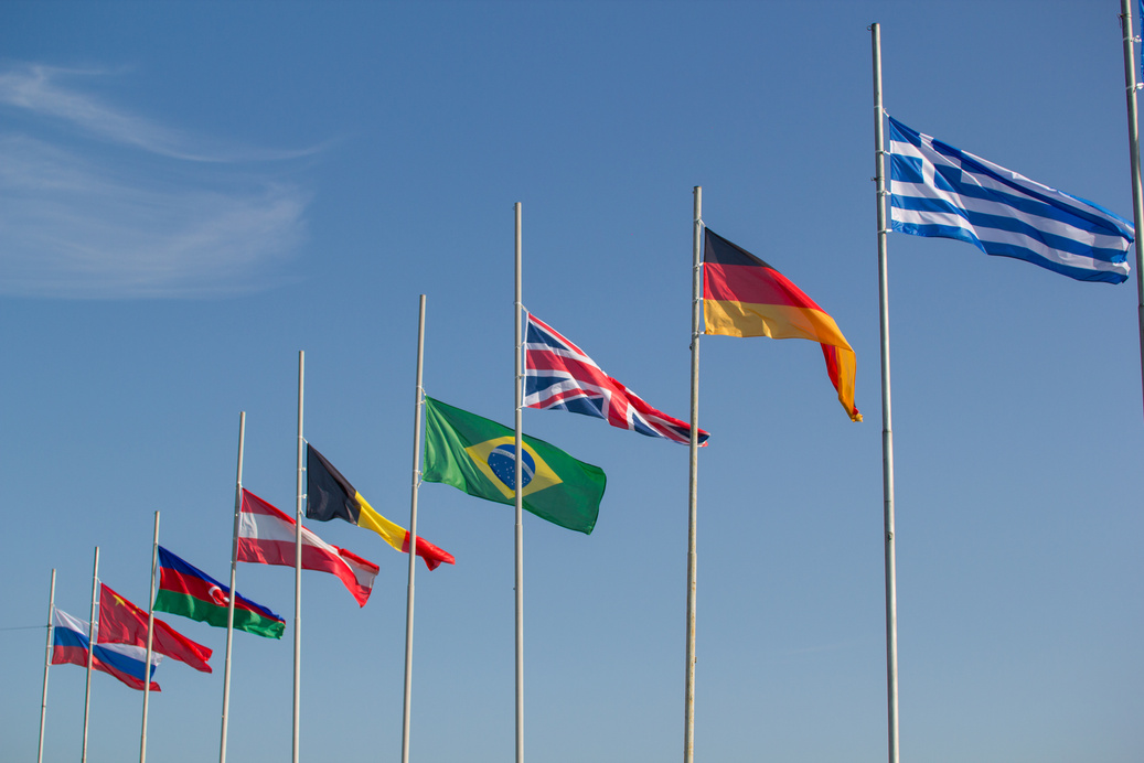Flags of the world countries blowing in the wind on a background of the sky